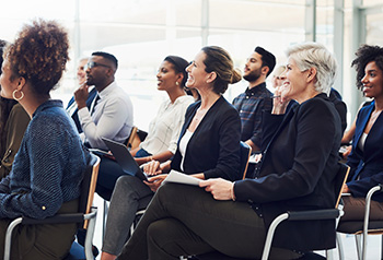 An audience of business people attending a conference.