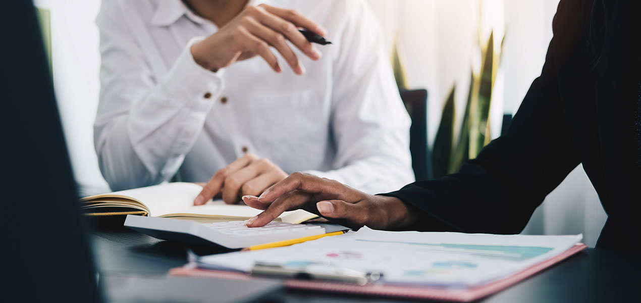Two business people checking documents.