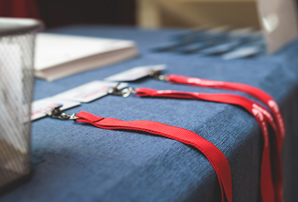 Three conference name badges sitting on a welcoming table.