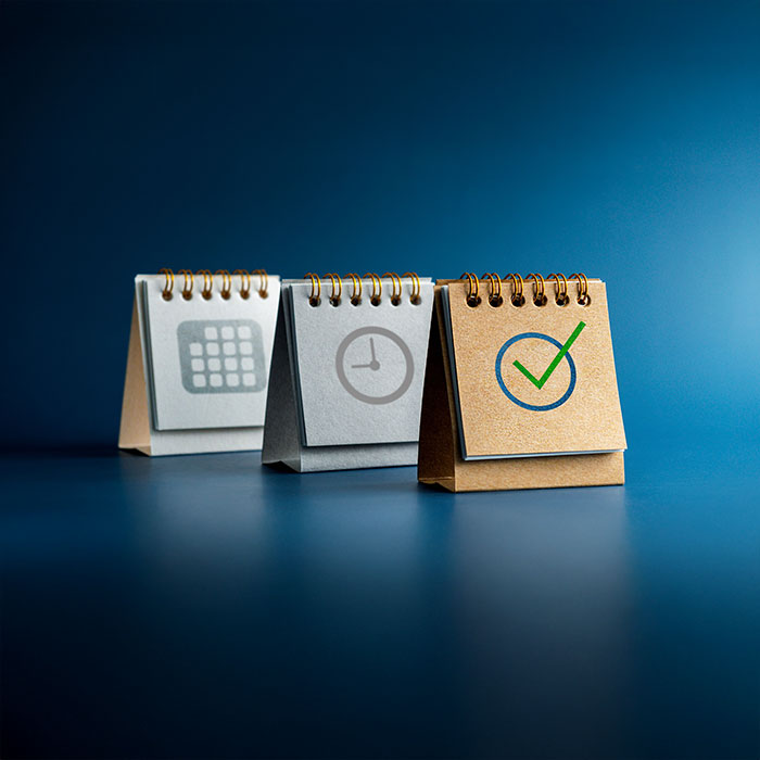 Three flip charts with a calendar, a clock and a checkmark.