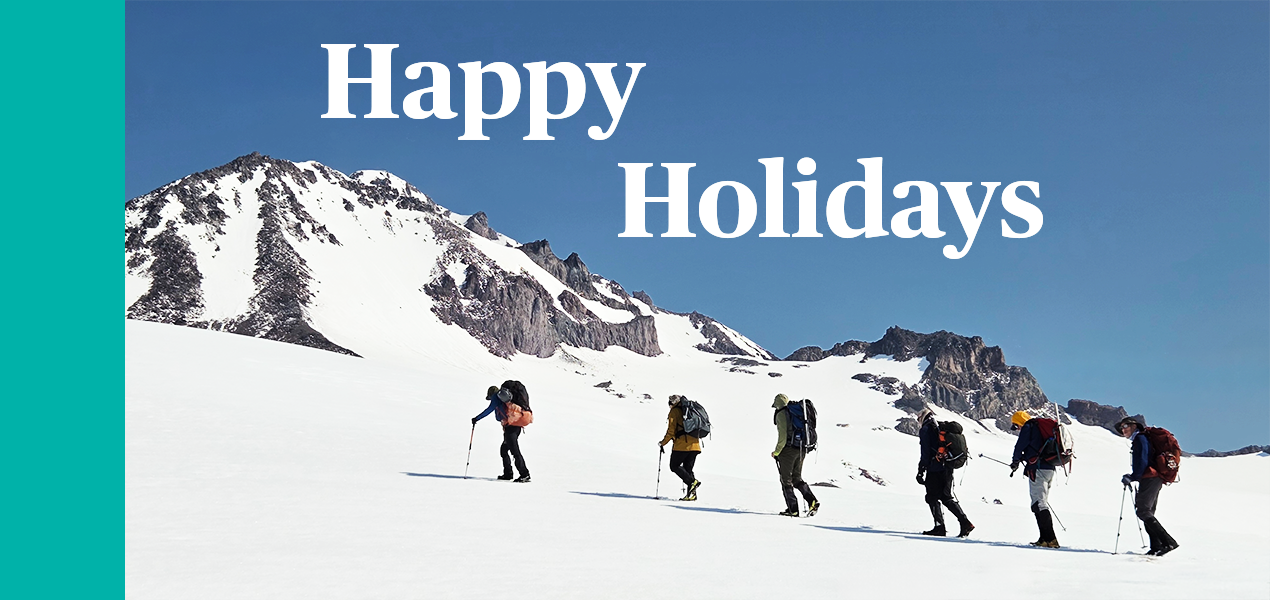 Six hikers walking up a snowy peak with "Happy Holidays" in the sky above.
