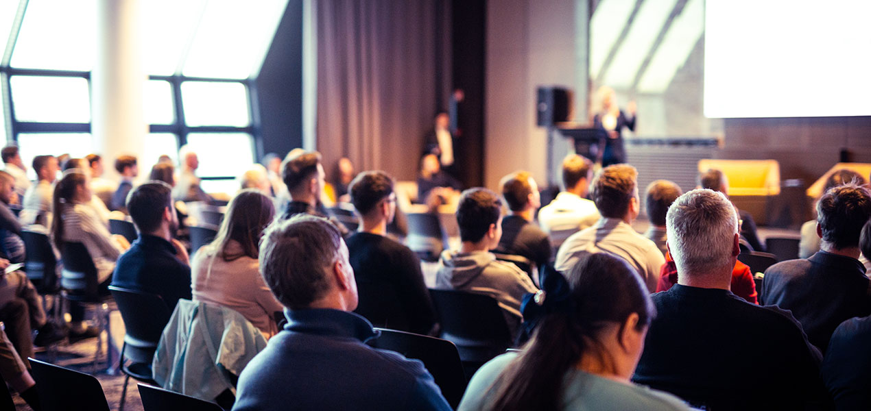 Conference attendees listening to a presentation.