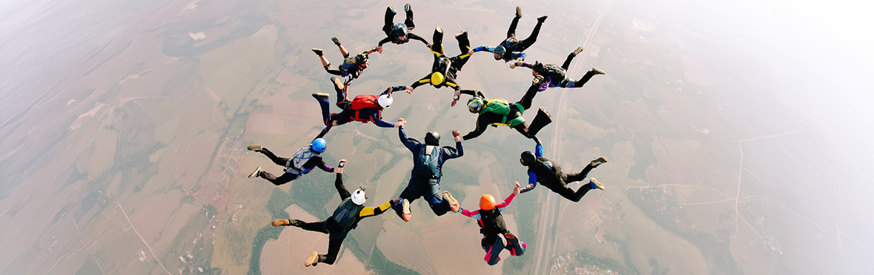 A collage of headshots of diverse people against dark and colourful backdrops.