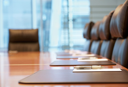 A close up shot of an empty boardroom table.
