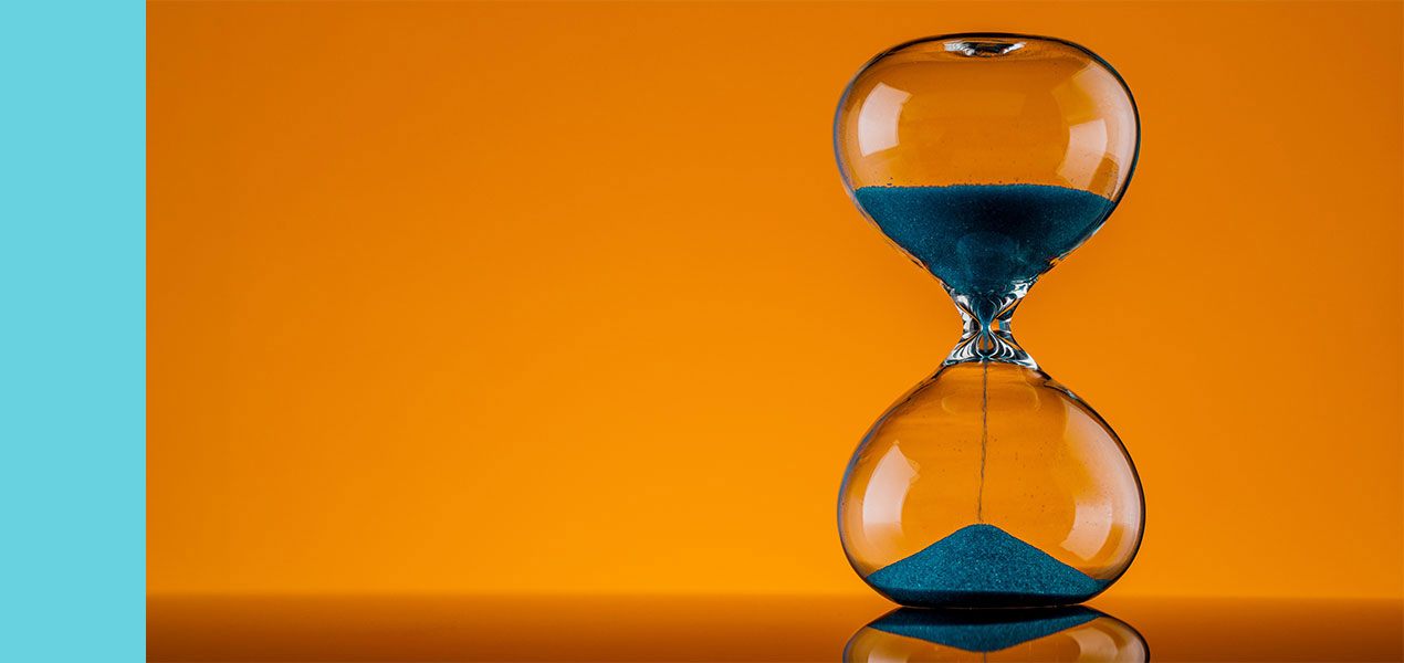 A large hourglass with the sand falling from the top to the bottom
