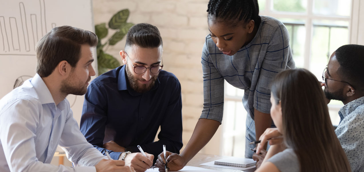 A diverse group of individuals collaborating on a project, sharing ideas and working together in a professional setting.